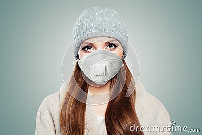 Pretty woman in season clothes and protective medical mask on white Stock Photo