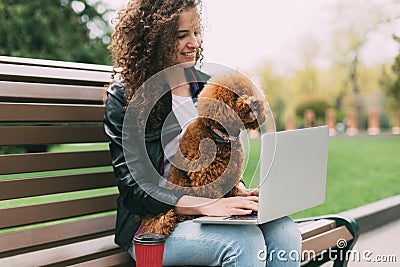 Pretty woman spending some time with her dog at park Stock Photo