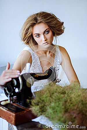 Pretty Woman. In the style of Coco Chanel sitting on a sewing machine Stock Photo