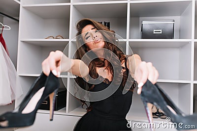 Pretty woman in wardrobe can`t make choice Stock Photo