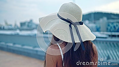 pretty woman wearing white dress pamela hat walking over beach terrace sea happy summer vacation pretty woman wearing 152694242