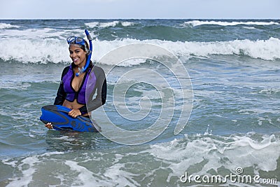 Pretty woman in wetsuit going snorkeling Stock Photo