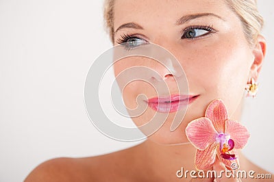 Pretty woman whith pure healthy skin and orchid Stock Photo