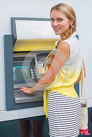 Pretty woman withdrawing money. Stock Photo