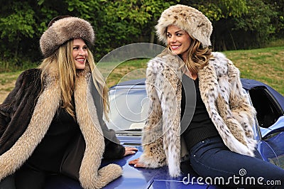 Pretty women wearing winter fur coats Stock Photo