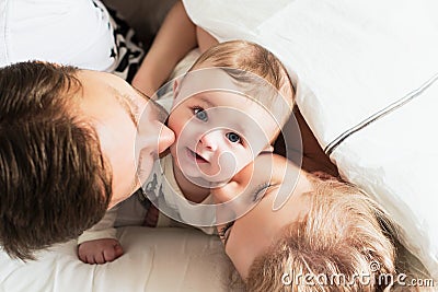 Pretty yong family in bed Stock Photo