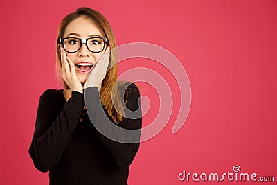Pretty young asian woman in the studio looking shocked Stock Photo