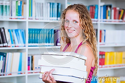 Pretty, young college student in a library Stock Photo