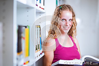 Pretty, young college student in a library Stock Photo