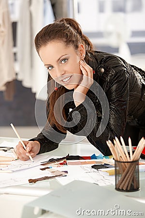 Pretty young fashion designer working in studio Stock Photo