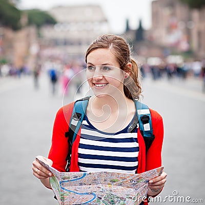 Pretty young female tourist holding a map Stock Photo