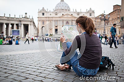 Pretty young female tourist studying a map Stock Photo