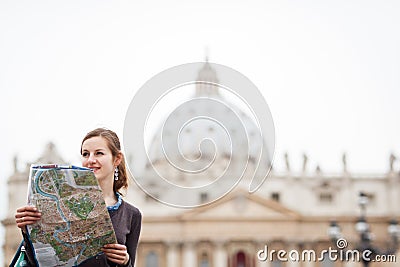 Pretty young female tourist studying a map Stock Photo