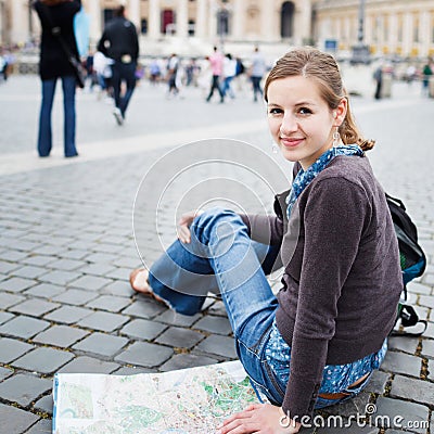 Pretty young female tourist studying a map Stock Photo