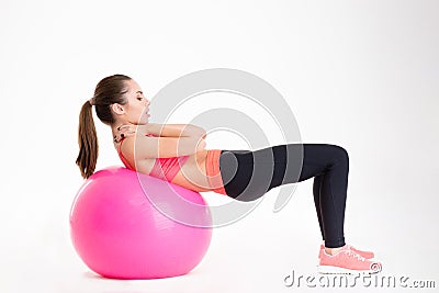 Pretty young fitness woman working out with fitball Stock Photo