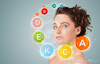 Pretty young girl with colorful vitamin icons and symbols Stock Photo