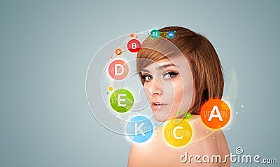 Pretty young girl with colorful vitamin icons and symbols Stock Photo