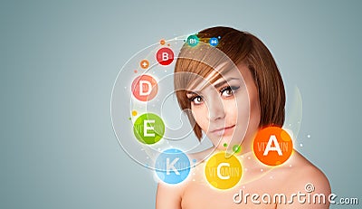 Pretty young girl with colorful vitamin icons and symbols Stock Photo