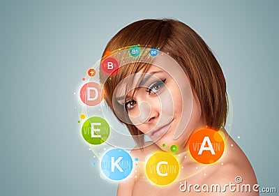 Pretty young girl with colorful vitamin icons and symbols Stock Photo