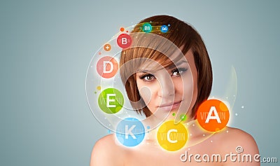 Pretty young girl with colorful vitamin icons and symbols Stock Photo