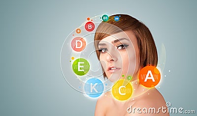 Pretty young girl with colorful vitamin icons and symbols Stock Photo