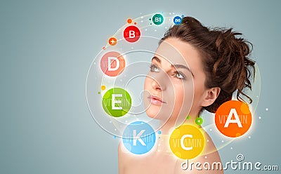 Pretty young girl with colorful vitamin icons and symbols Stock Photo