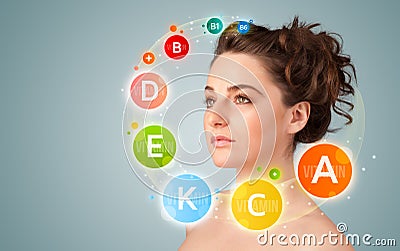Pretty young girl with colorful vitamin icons and symbols Stock Photo