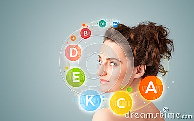 Pretty young girl with colorful vitamin icons and symbols Stock Photo