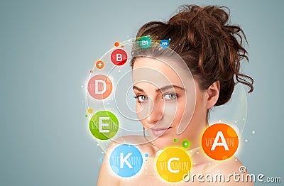 Pretty young girl with colorful vitamin icons and symbols Stock Photo