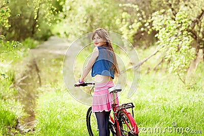 Pretty young girl holding bike. Stock Photo