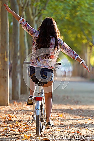 Pretty young girl riding bike in a forest. Stock Photo