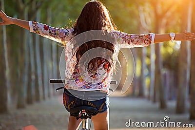 Pretty young girl riding bike in a forest. Stock Photo