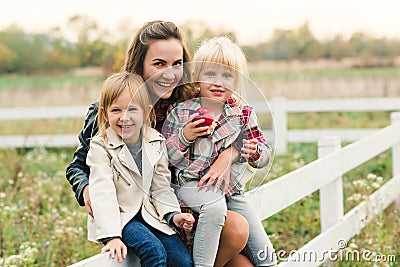 Pretty young mother having fun together with her daughters. Happy loving family. Stylish lovely mother with kids. Family enjoing Stock Photo