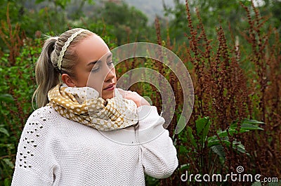Pretty young reflective woman looking up in a mountain Stock Photo