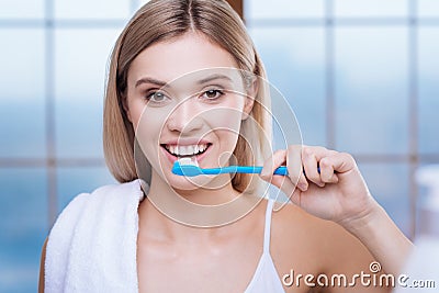 Pretty young woman brushing her teeth in the morning Stock Photo