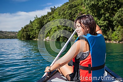 Pretty, young woman on a canoe on a lake Stock Photo