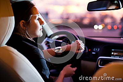Pretty, young woman driving her modern car Stock Photo
