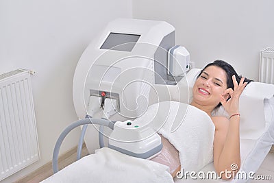Pretty young woman getting cryolipolyse treatment in professional cosmetic cabinet Stock Photo