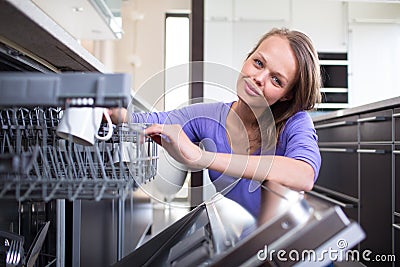 Pretty, young woman in her modern and well equiped kitchen Stock Photo