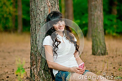 Pretty young woman holdiing mobile phone and smile Stock Photo