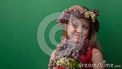 Pretty young woman incomparable in a lilac wreath with a charismatic appearance rejoices. Make up grimace Stock Photo