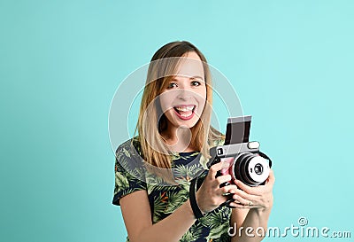 Pretty young woman with instant camera Stock Photo