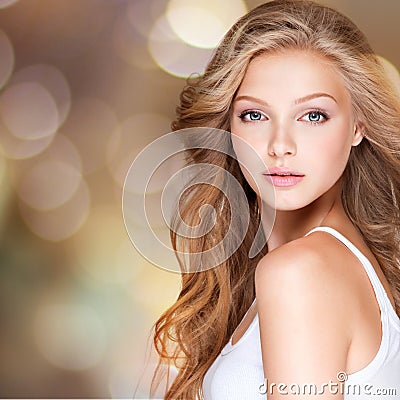 Pretty young woman with long curly hair.