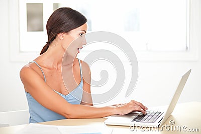 Pretty young woman looking shocked while studying Stock Photo