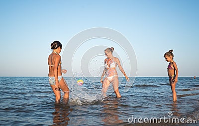 Pretty young woman plays ball with her daughters Stock Photo