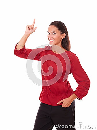 Pretty young woman pointing up and smiling Stock Photo