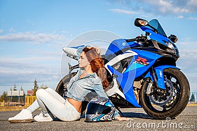 Pretty young woman and Suzuki GSX-R750 Editorial Stock Photo