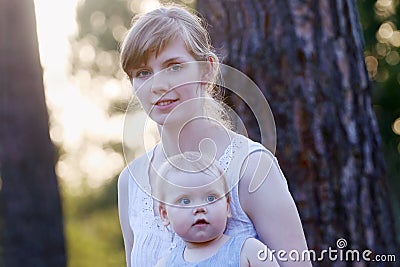 Pretty young woman in white and her little cute daughter Stock Photo