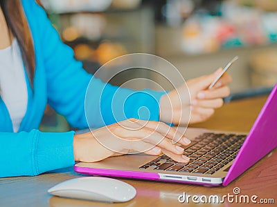 Pretty Young womans hands holding a credit card Stock Photo