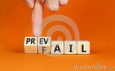 Prevail or fail symbol. Concept words Prevail or Fail on wooden cubes. Businessman hand. Beautiful orange table orange background Stock Photo